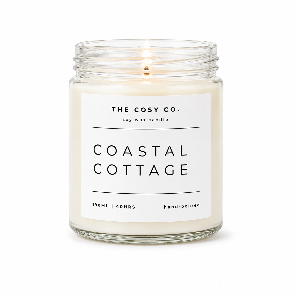 The Cosy Co Coastal Cottage soy candle in clear glass jar with fresh sea breeze and driftwood fragrance