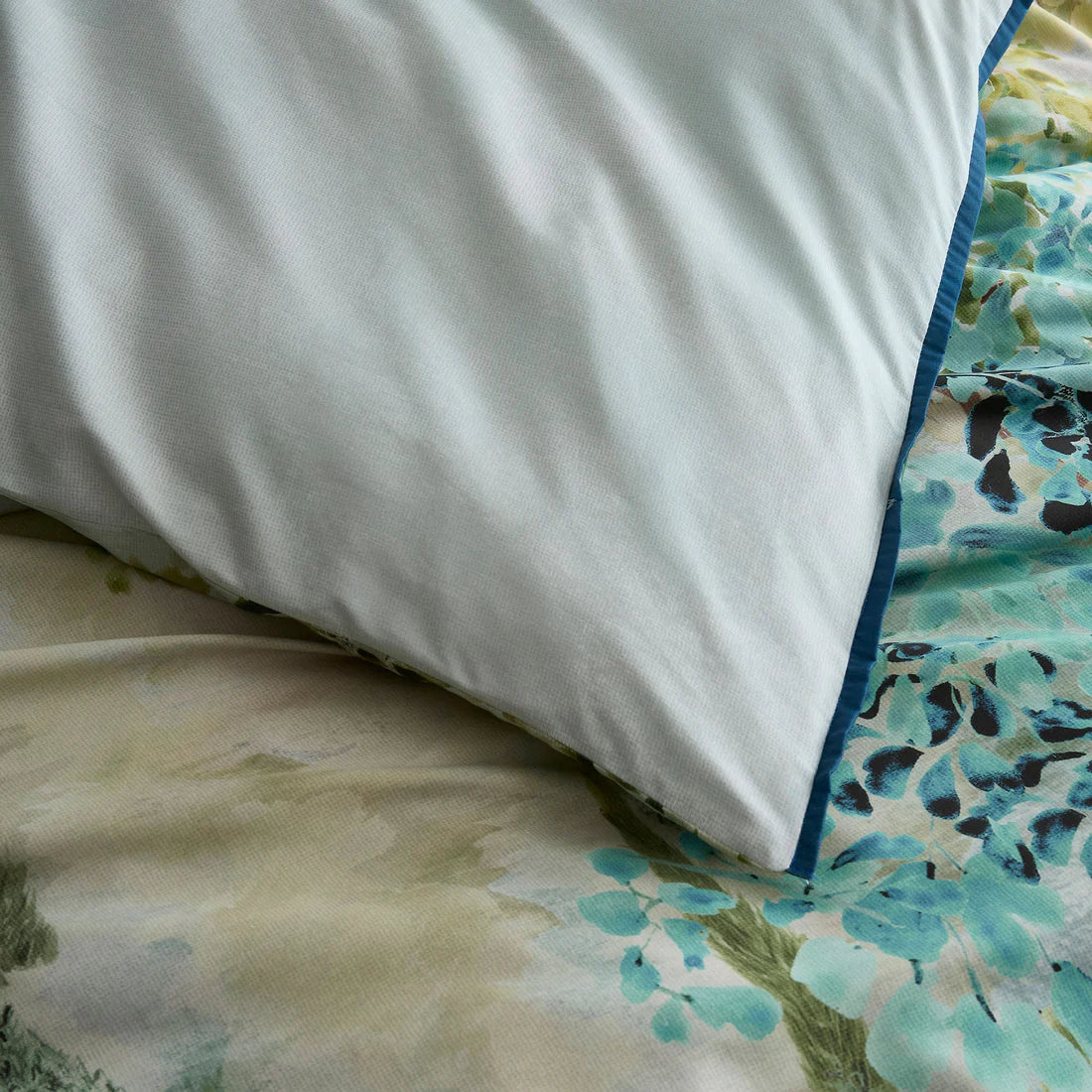 Soiree Hidden Garden duvet cover set in green with layered botanical foliage design and 200 thread count cotton