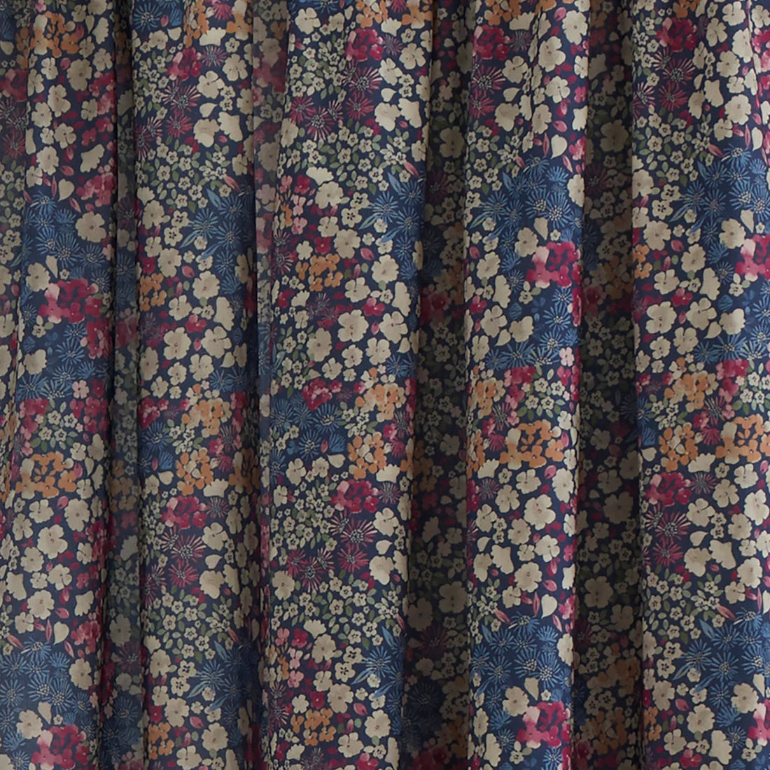 Dreams & Drapes Bessie pencil pleat curtains in navy with floral print and matching tiebacks