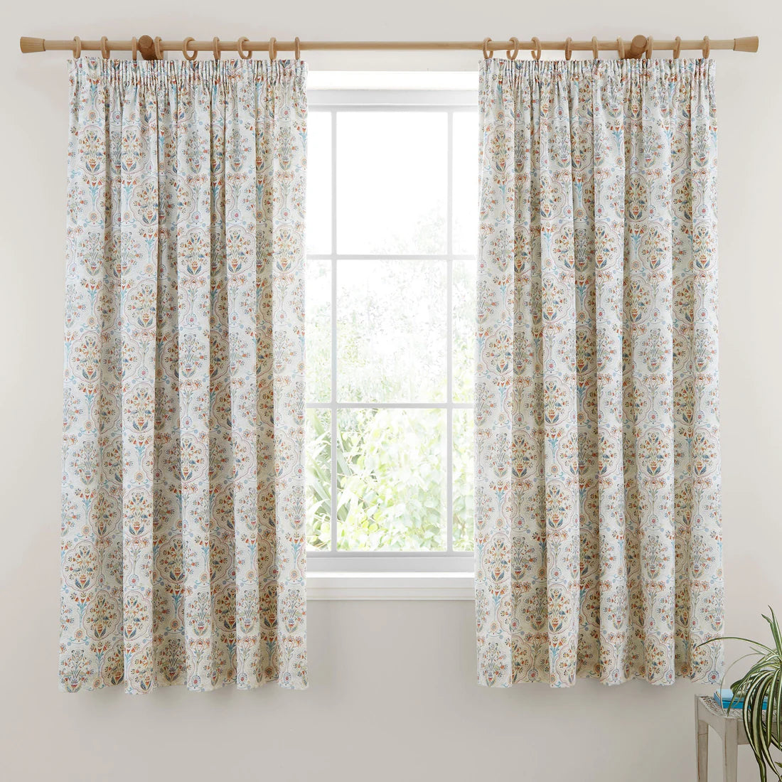 Dreams & Drapes Edena pencil pleat curtains in natural featuring elegant floral detailing in teal, gold and coral tones