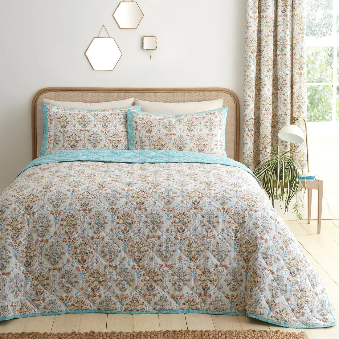 Dreams & Drapes Edena quilted bedspread in natural featuring elegant floral detailing in teal, gold and coral tones
