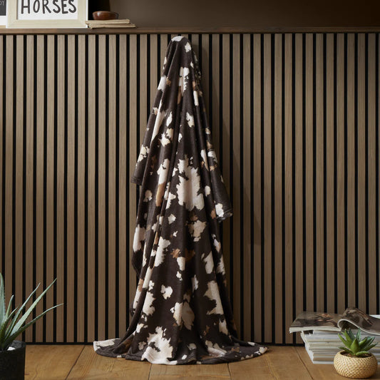 Fusion Cow Print fleece throw in chocolate with soft cowhide-inspired countryside design