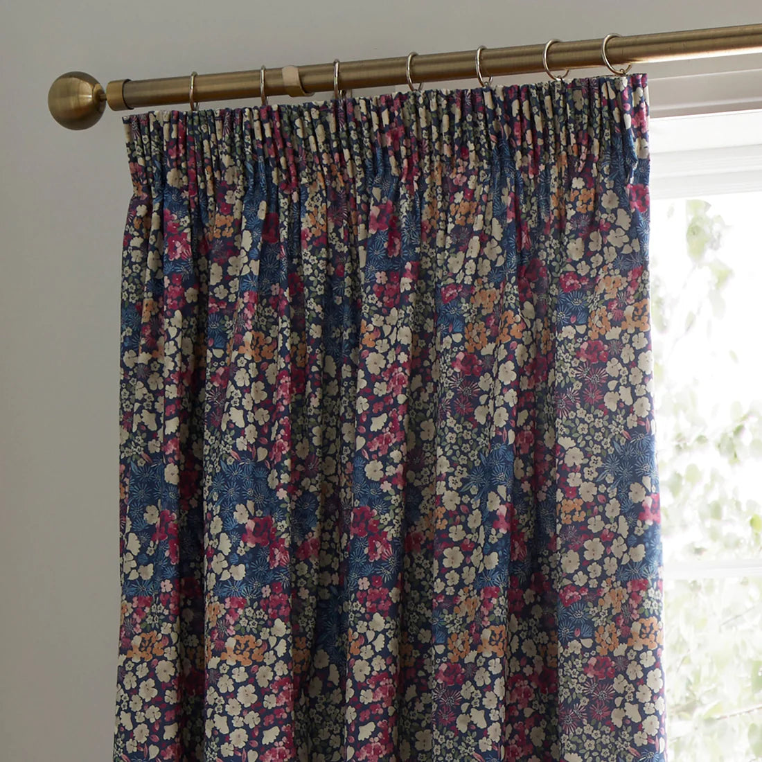 Dreams & Drapes Bessie pencil pleat curtains in navy with floral print and matching tiebacks