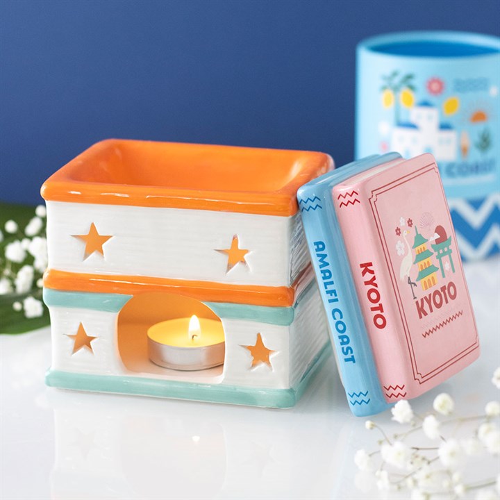Travel Book Stack ceramic oil burner and wax warmer inspired by colourful travel guide books